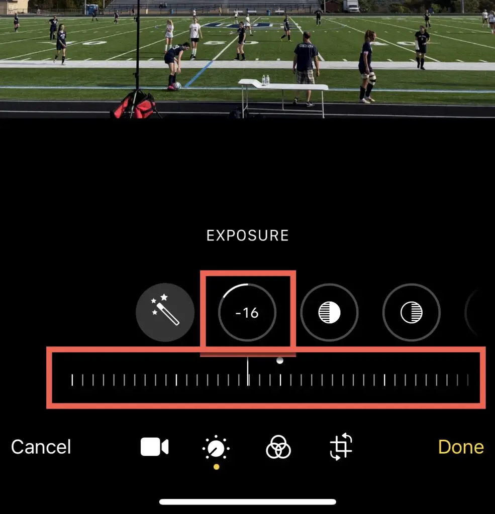 Slide the exposure slide to adjust exposure levels for video clip in Photos for iOS